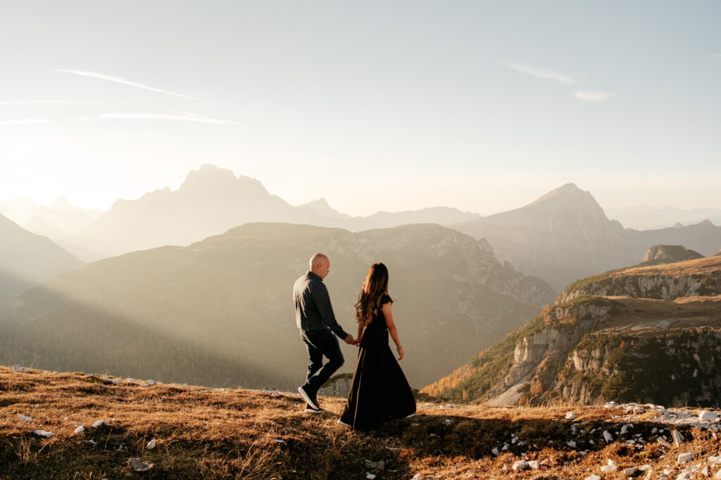 Couple walking on mountain during sunset