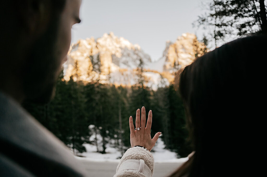 Engaged couple with mountain view in background.