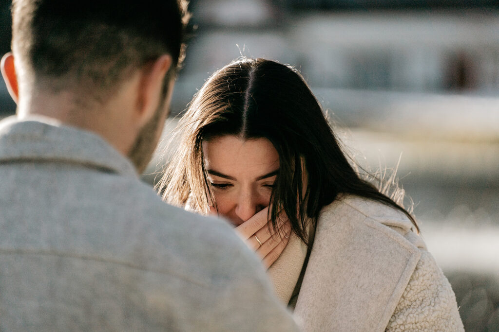 Woman surprised, covering mouth with hand.