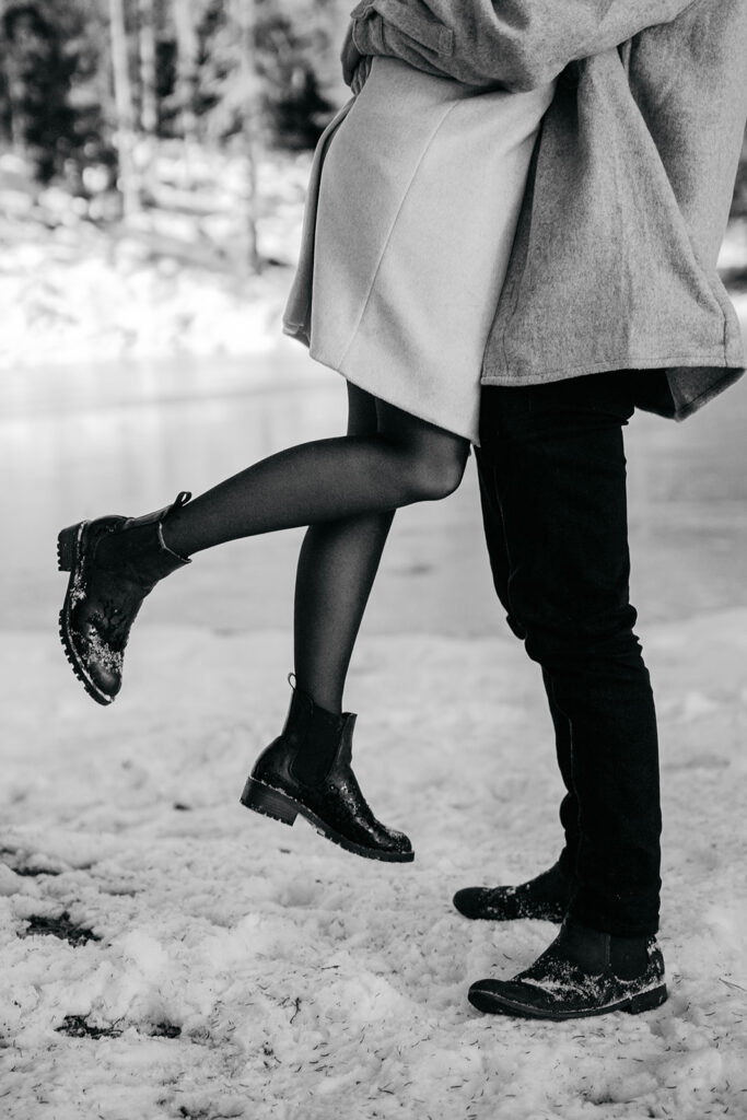 Couple embracing, snowy background, winter romance scene.