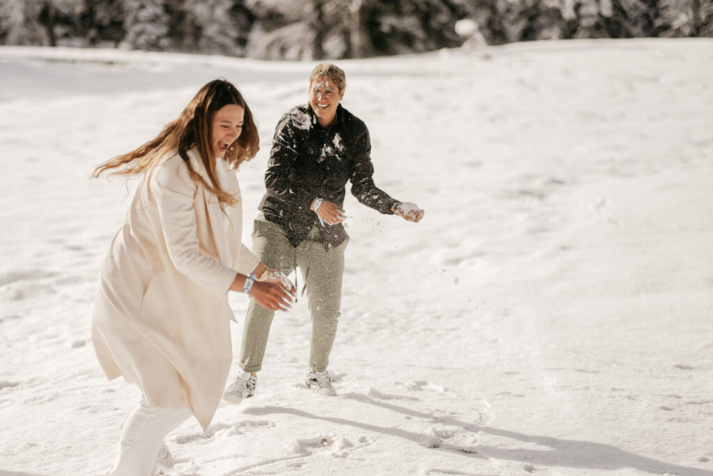 Two people having a snowball fight.