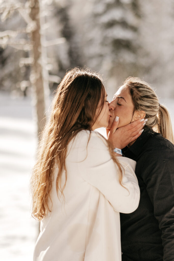 Couple kissing in snowy winter landscape