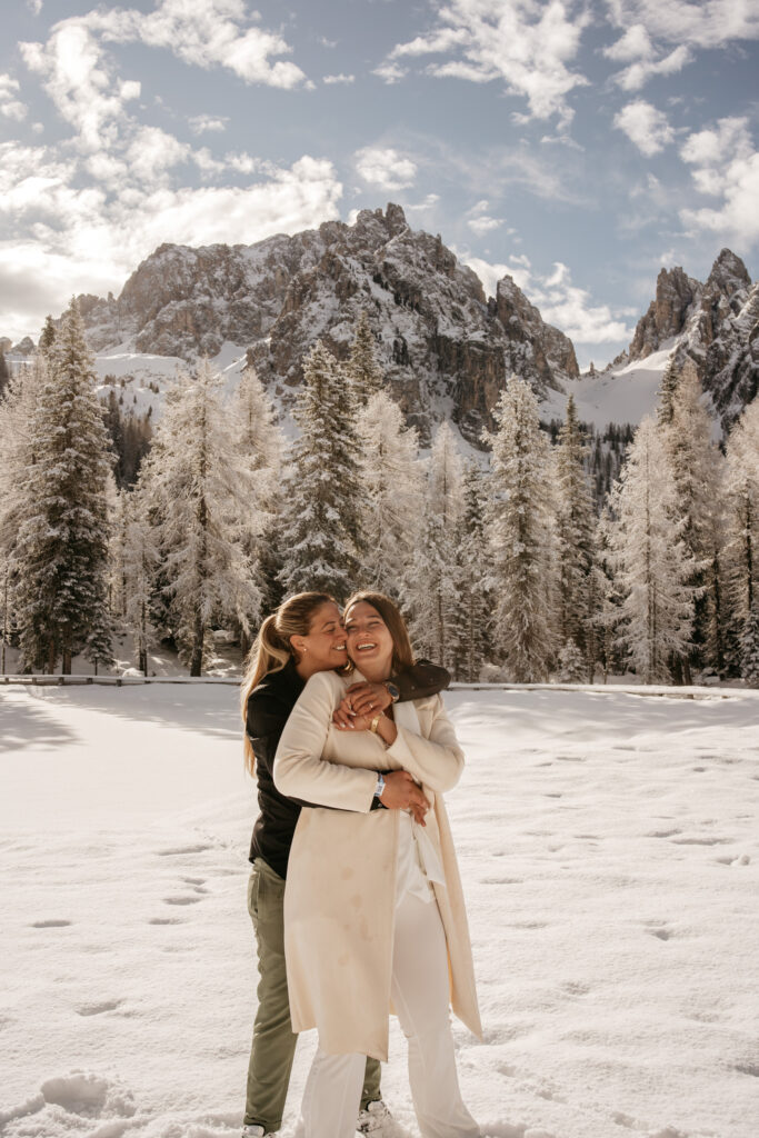 Couple embracing in snowy mountain landscape