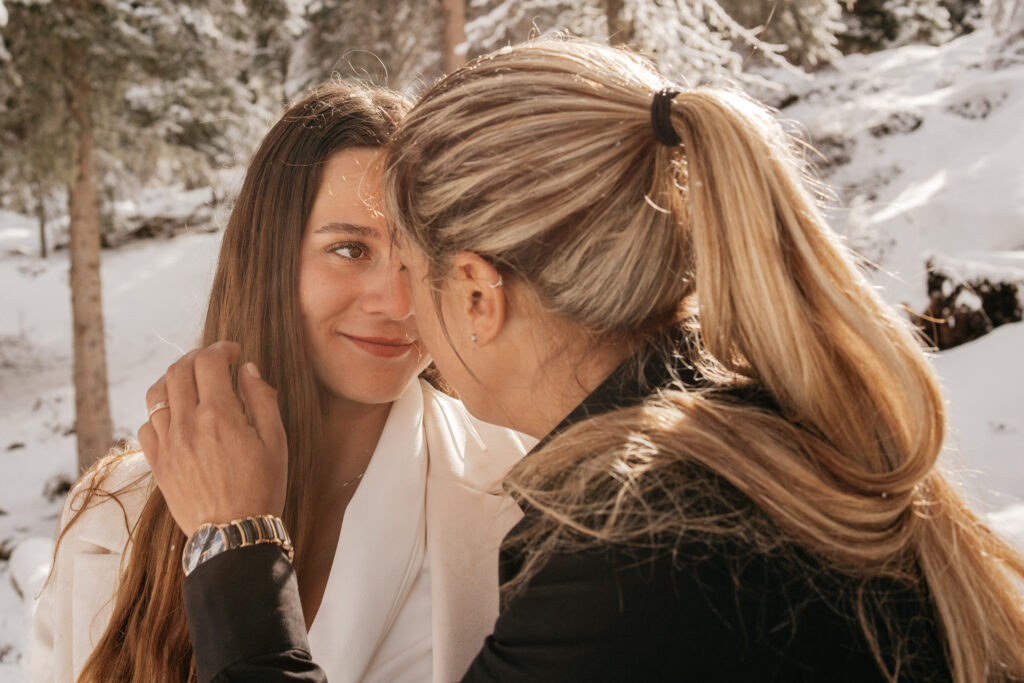 Couple embracing in snowy forest.