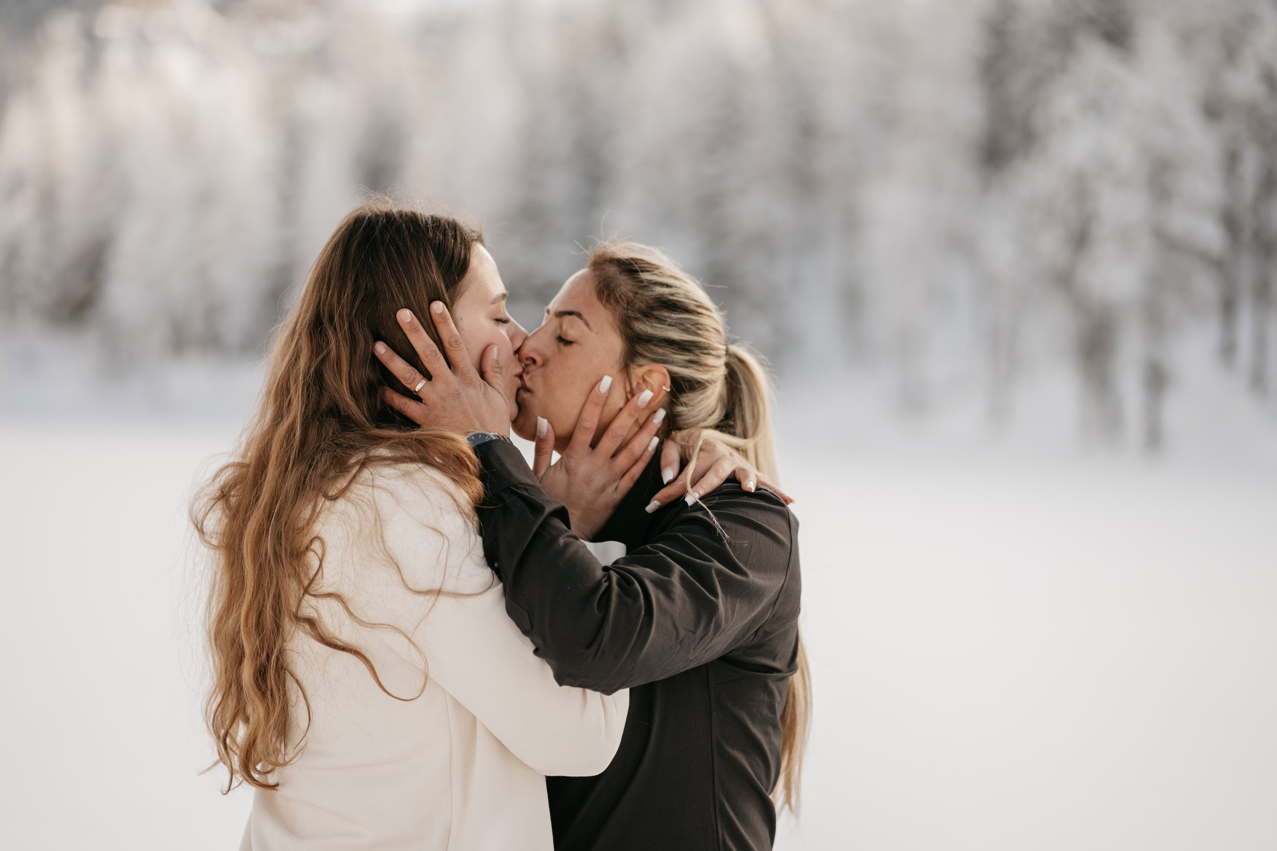 Couple kissing in snowy landscape