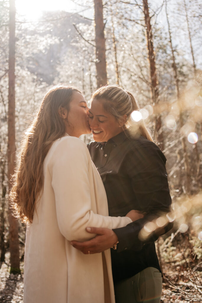 Couple embracing in a sunny forest