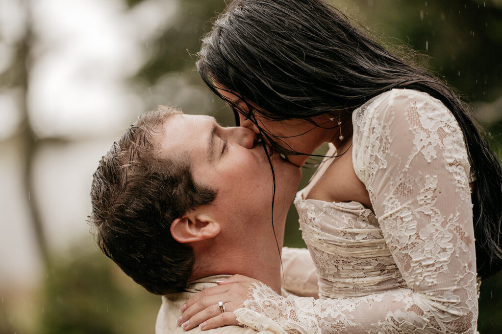 Couple kissing in the rain, wearing lace outfits.