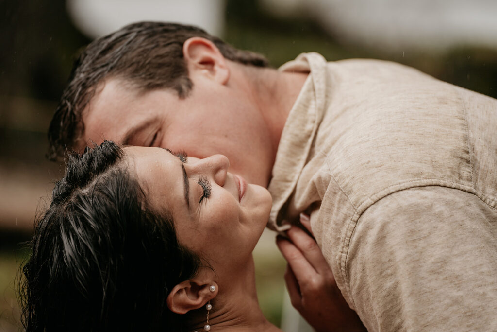 Couple in a romantic embrace outdoors.