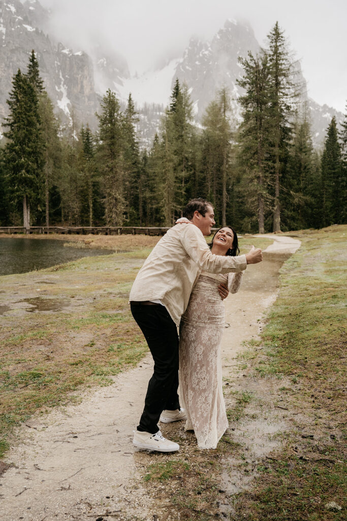 Couple laughing in a forested mountain area.