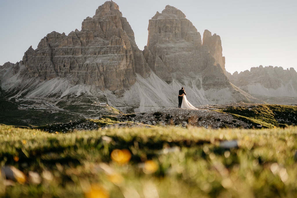 Couple embracing in scenic mountain landscape.