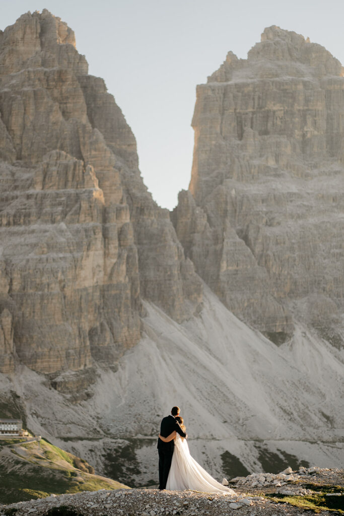 Couple embracing in front of mountain landscape.