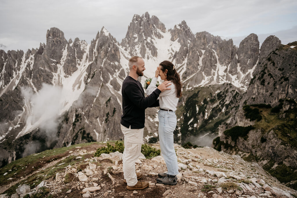 Couple embracing on mountain landscape background.