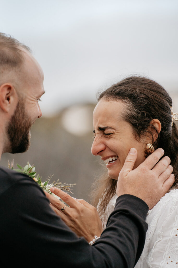 Couple smiling and embracing outdoors.