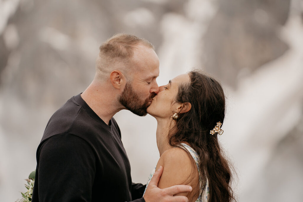 Couple kissing in a natural setting.