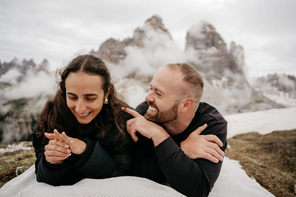 Smiling couple enjoying mountain view together.