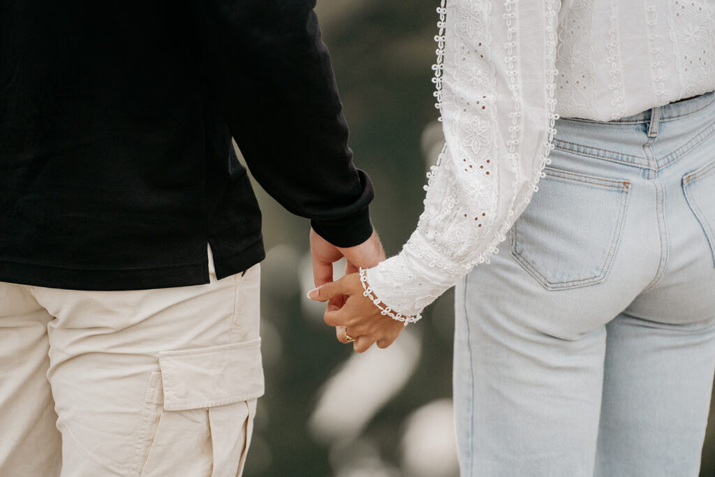 Couple holding hands outdoors close-up