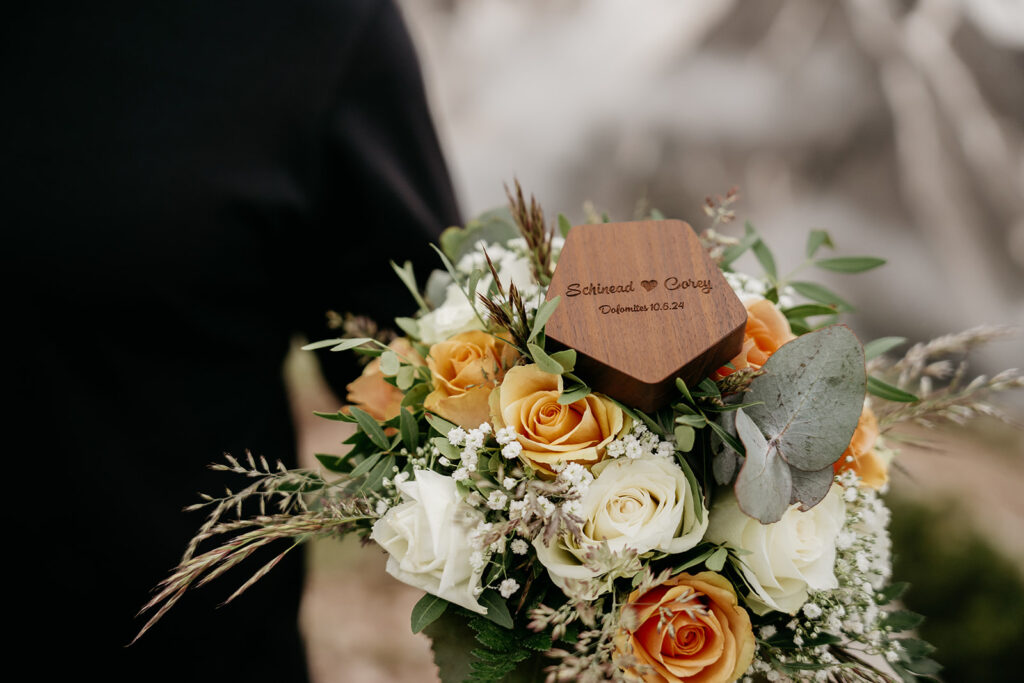 Floral bouquet with engraved wooden heart.