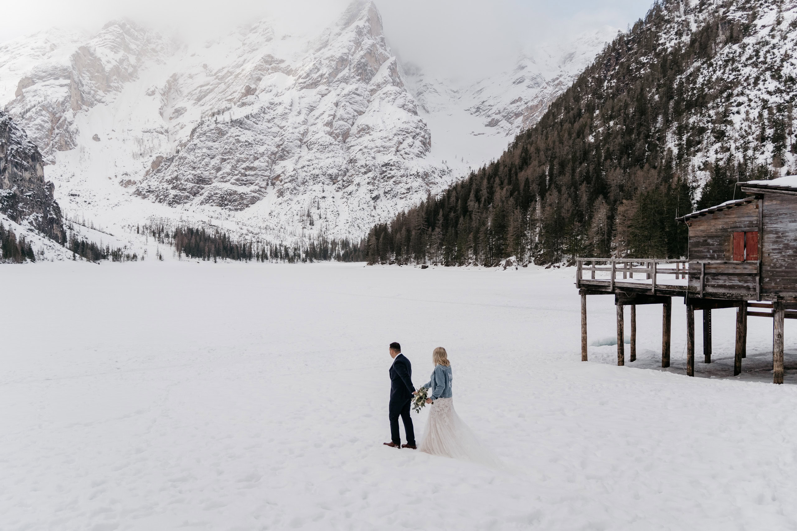 Couple walking on snowy mountain landscape