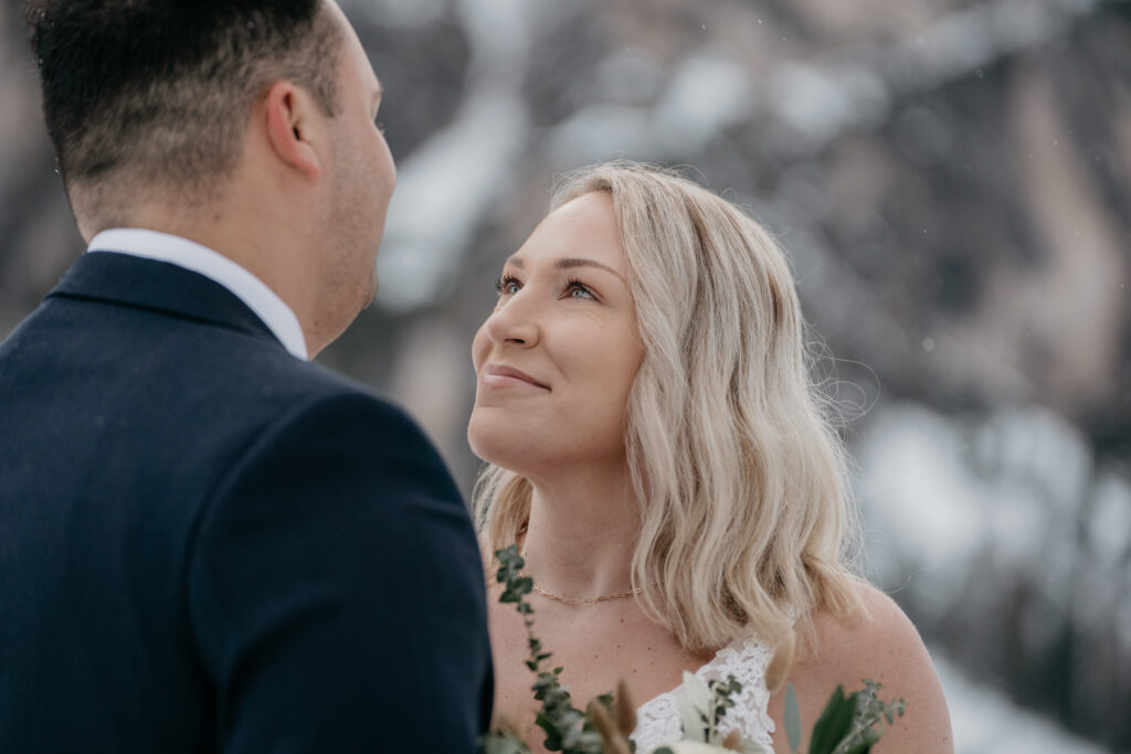 Couple looking at each other, winter wedding scene.