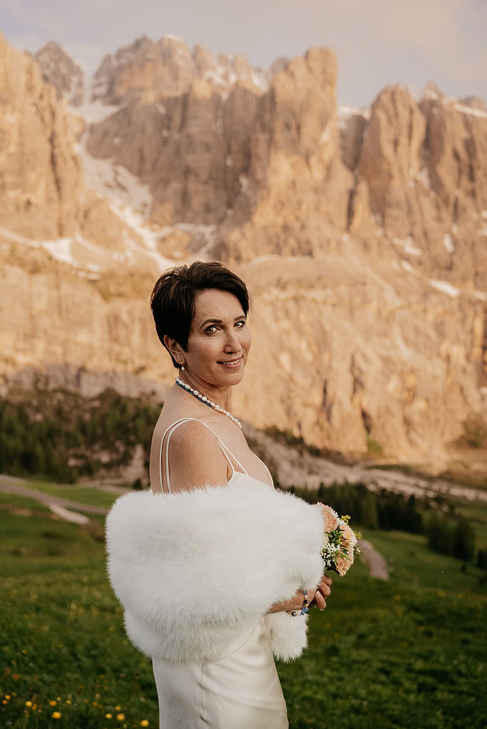 Woman in white shawl with mountain backdrop