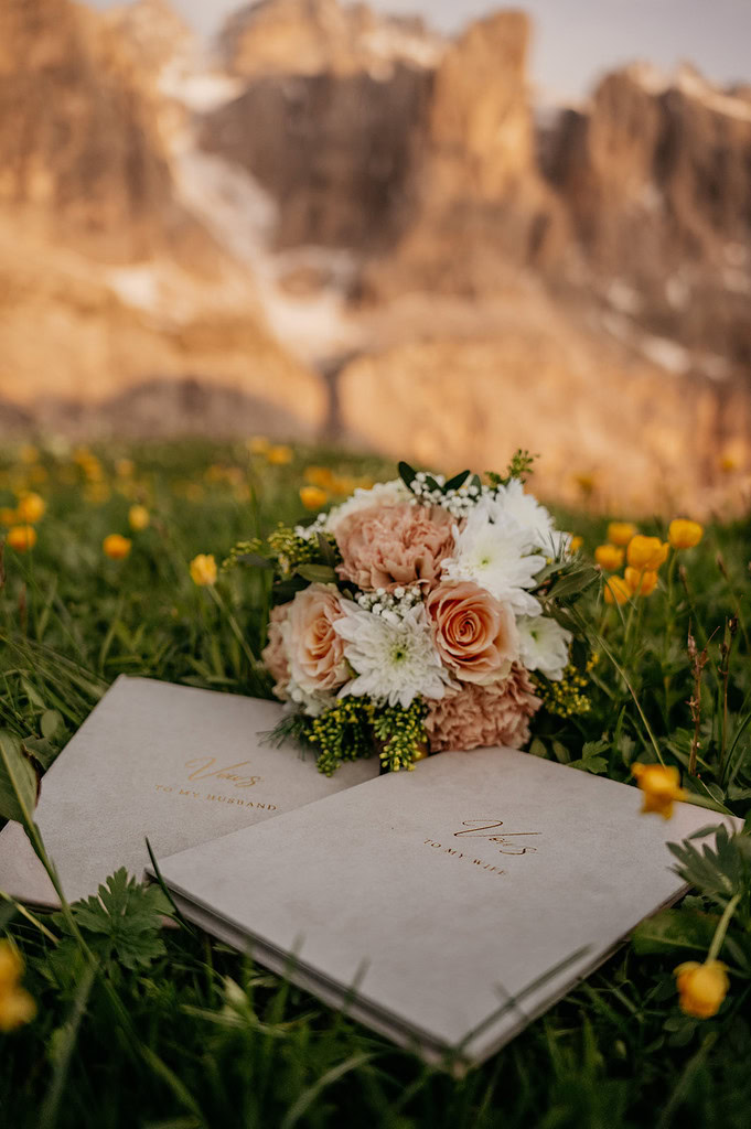 Wedding vows and bouquet in mountain meadow