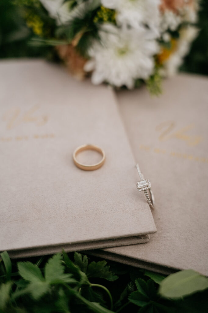 Wedding vows book with rings and flowers