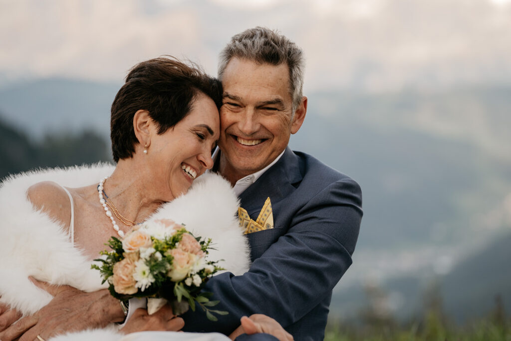 Smiling couple embracing with flowers outdoors