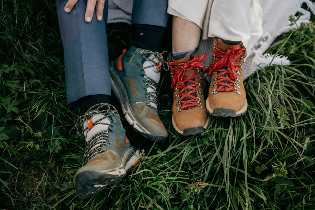 Couple wearing hiking boots on grass