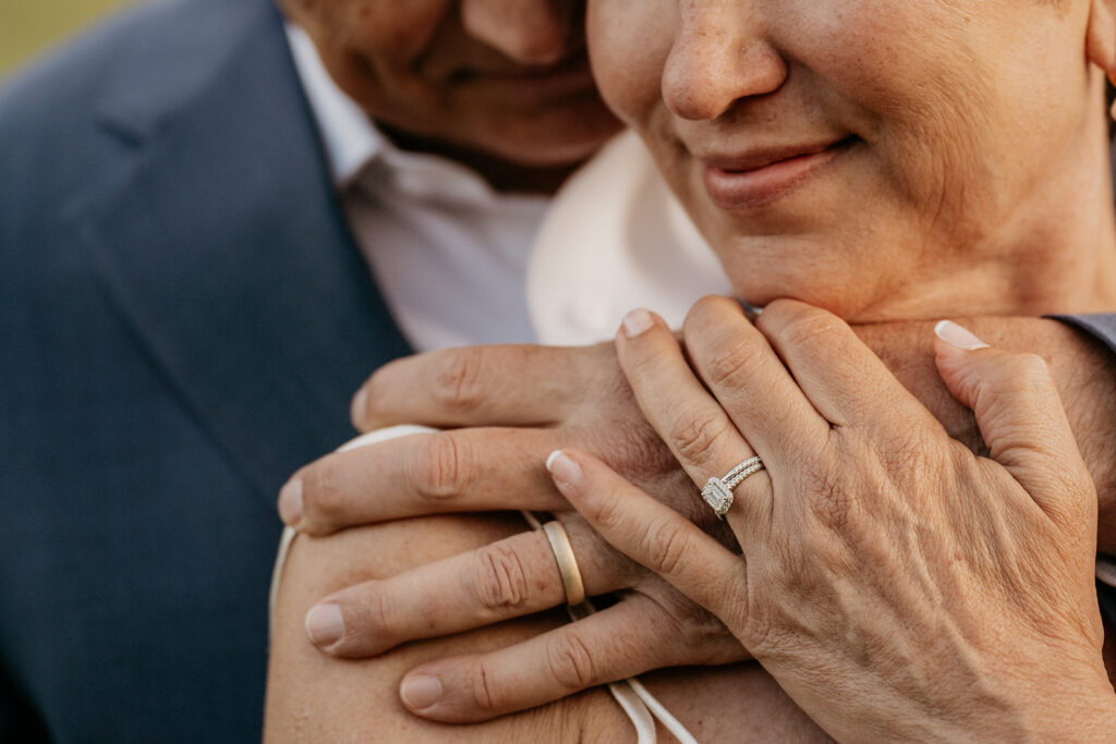 Close-up of couple's hands with wedding rings.