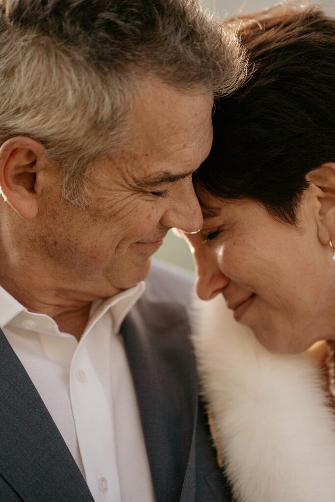 Elderly couple embracing, showing affection.