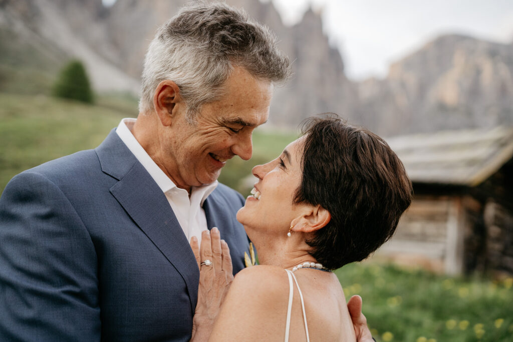 Couple smiling at each other outdoors.