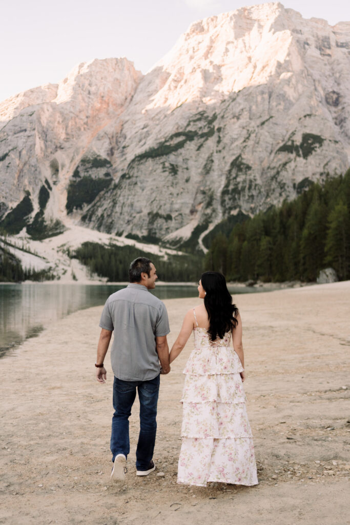 Couple holding hands by mountain lake