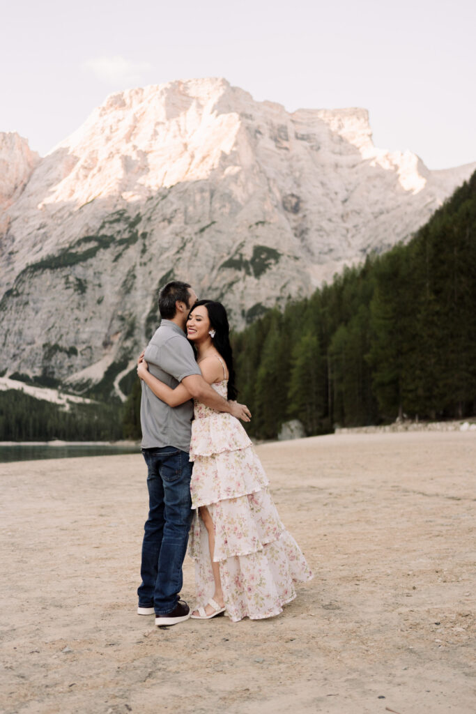 Couple hugging in scenic mountain backdrop