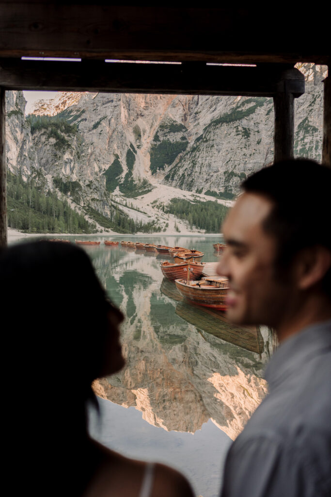 Peaceful lake with wooden boats and mountains