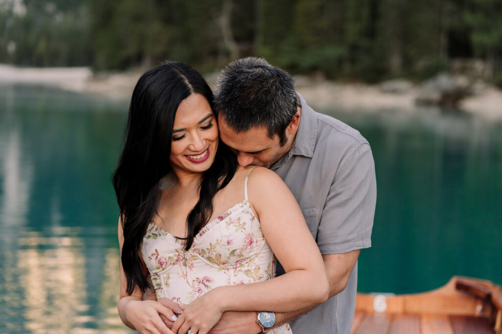 Couple hugging by a serene lake