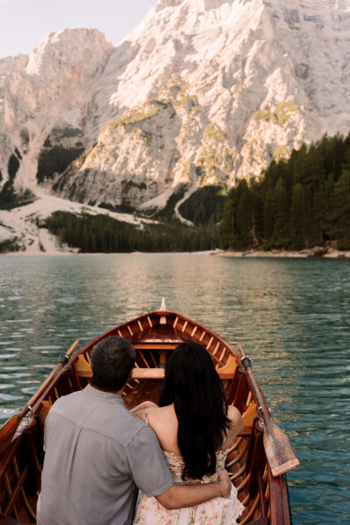 Couple in rowboat on mountain lake