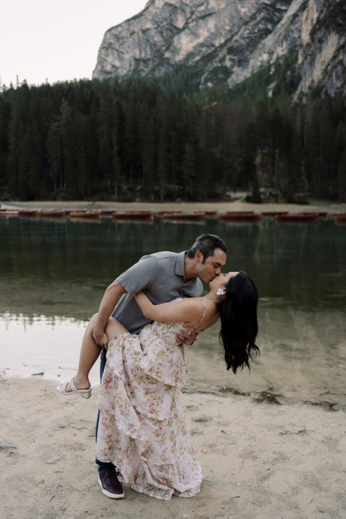 Couple kissing by a mountain lake