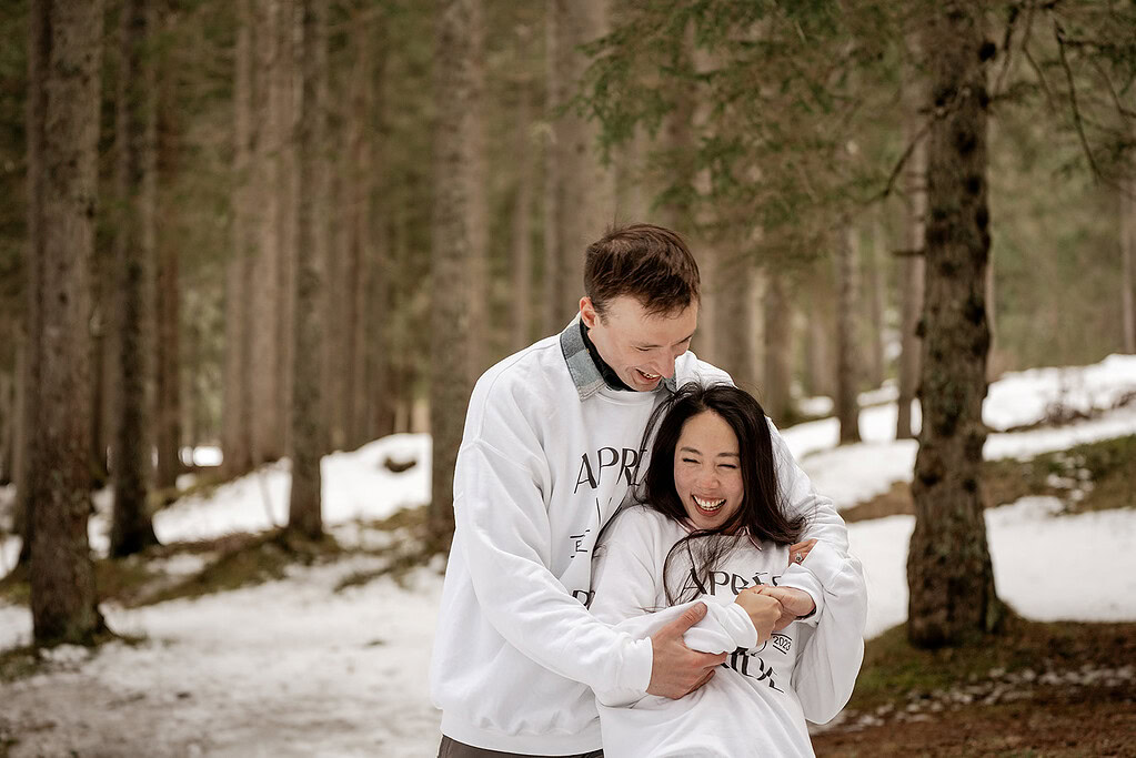 Couple laughing in snowy forest