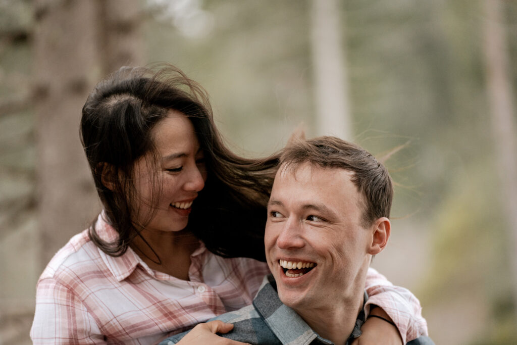 Happy couple smiling in a forest