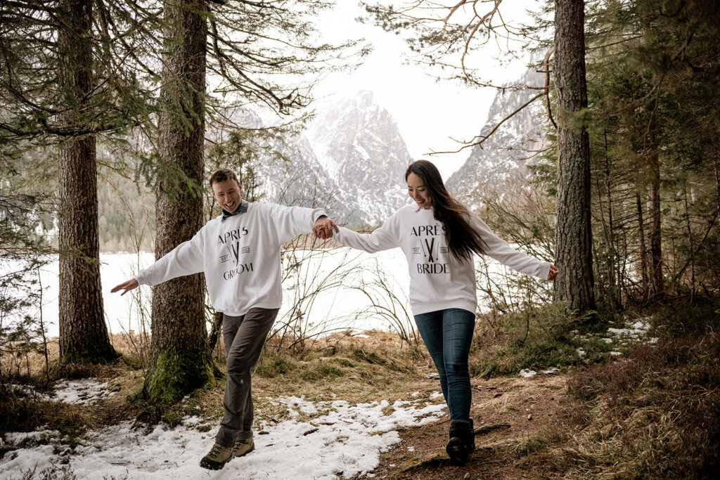 Couple holding hands in snowy forest