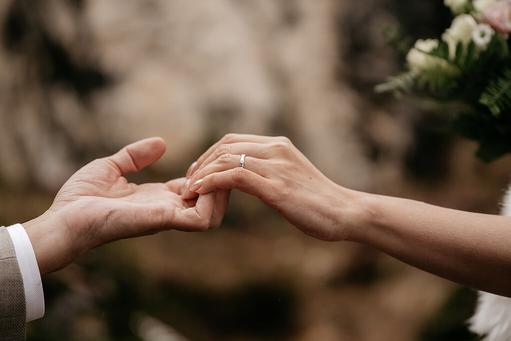 Bride and groom holding hands at wedding ceremony.