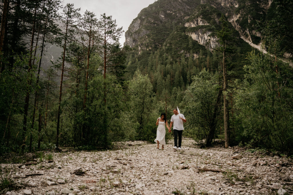 Couple walking in a mountain forest trail.