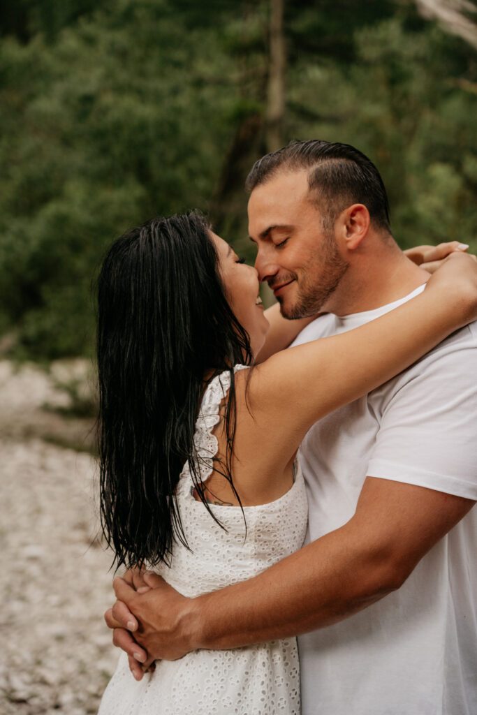 Couple embracing in a natural outdoor setting.