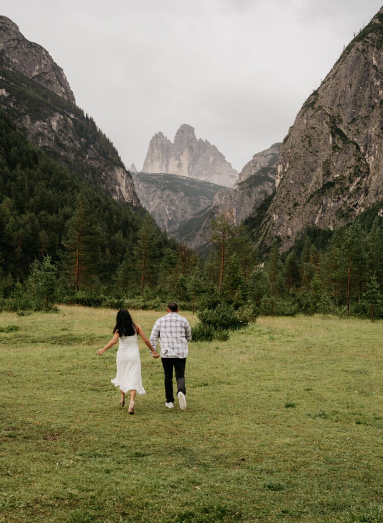 Couple walking in lush mountain valley