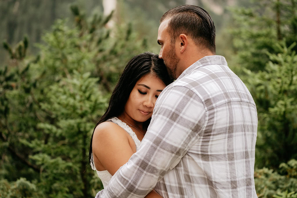 Couple embracing in a forest setting