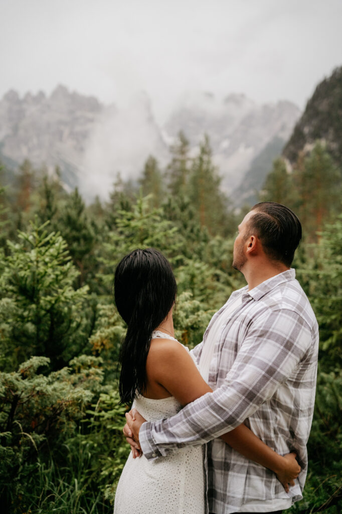 Couple embracing in a foggy mountain forest