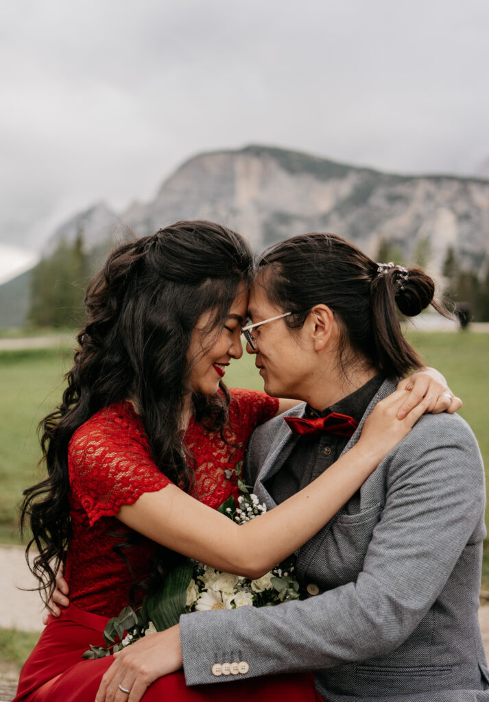 Couple embracing outdoors with mountains in background