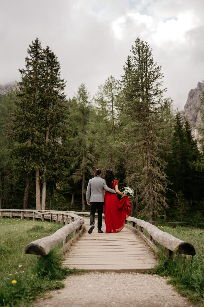 Couple walking on forest bridge, romantic setting