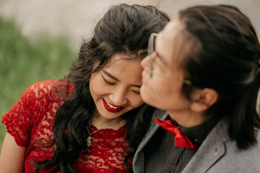 Couple embracing outdoors, smiling together.