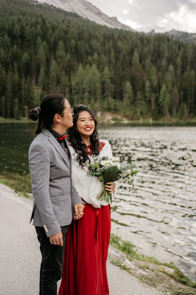 Couple smiling by a scenic lakeside view